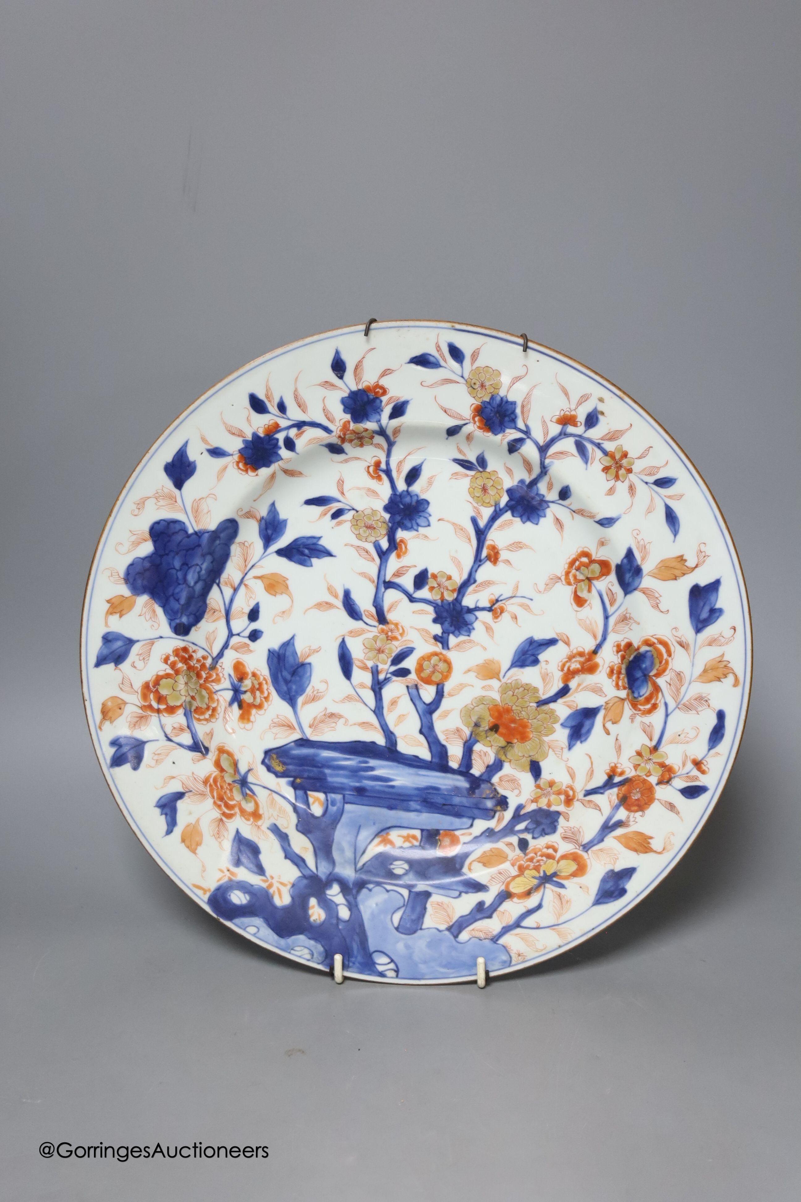 Three Japanese Imari plates together with a larger dish, 18th century, diameter 32cm